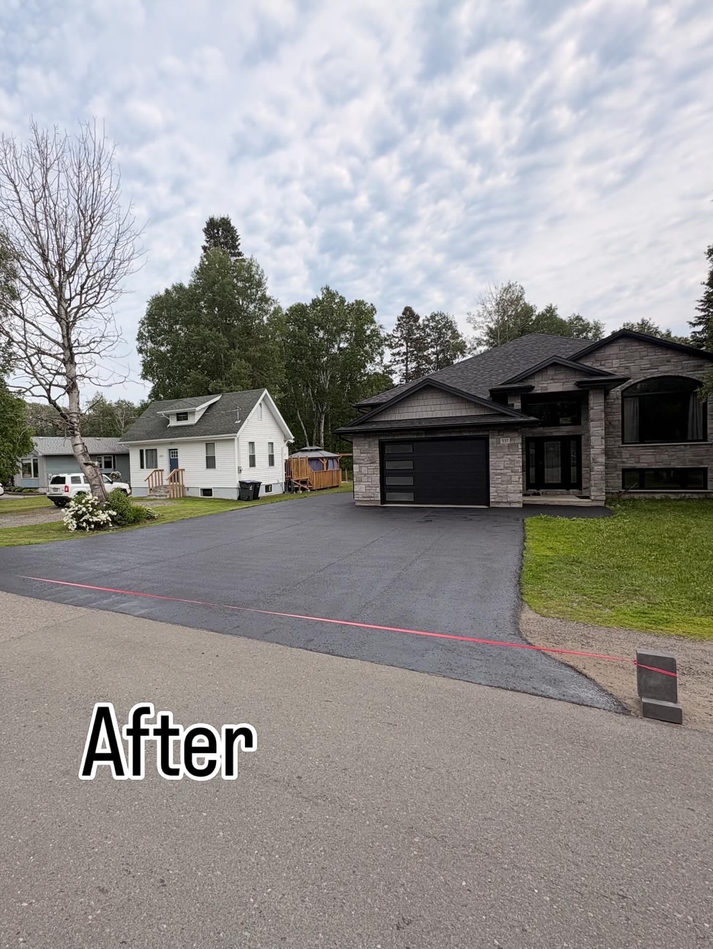 Smooth newly paved asphalt driveway after resurfacing