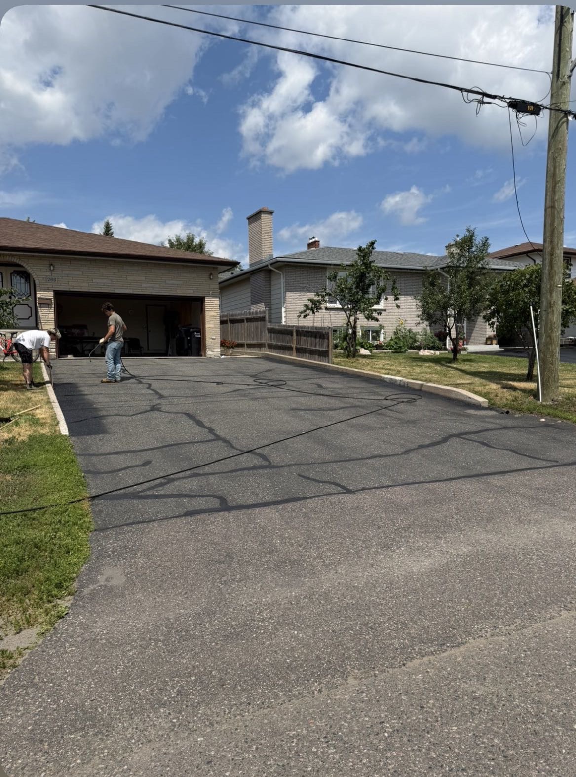 Driveway with extensive cracking being prepared for repair