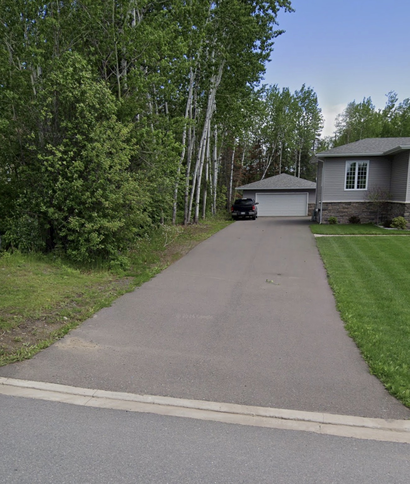 Worn, faded residential driveway before restoration