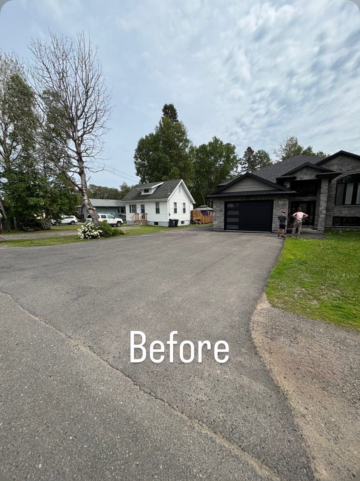 Cracked and faded asphalt driveway before resurfacing
