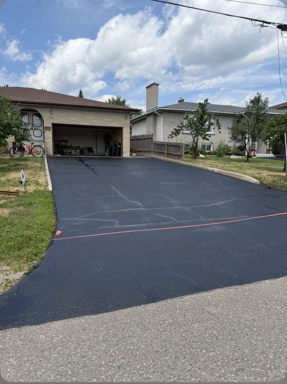 Driveway after crack repair and fresh sealcoating